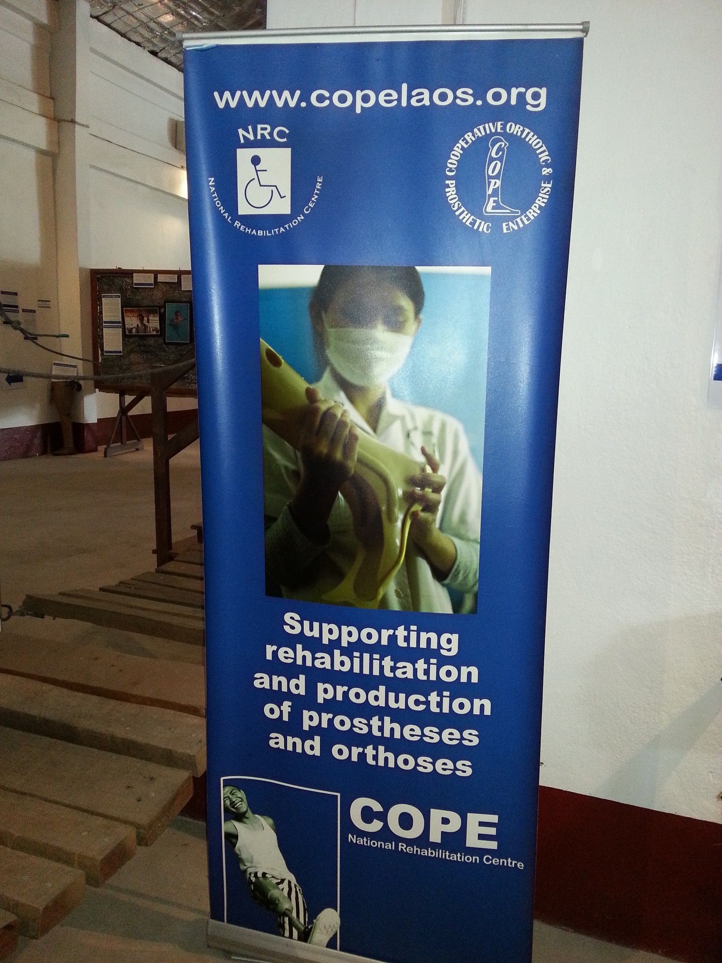 A banner of COPE encourage to supporting rehabilitation and production of prostheses and orthoses