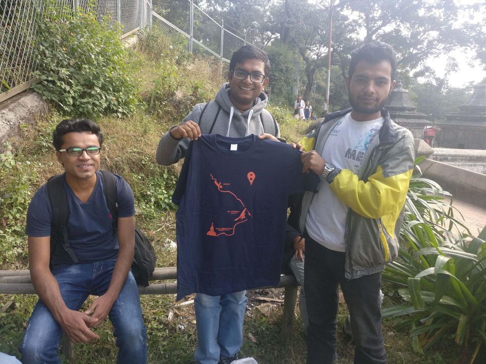 Saroj Dhakal giving Tshirt to BishowVijay (Nabin Sapkota sitting down)