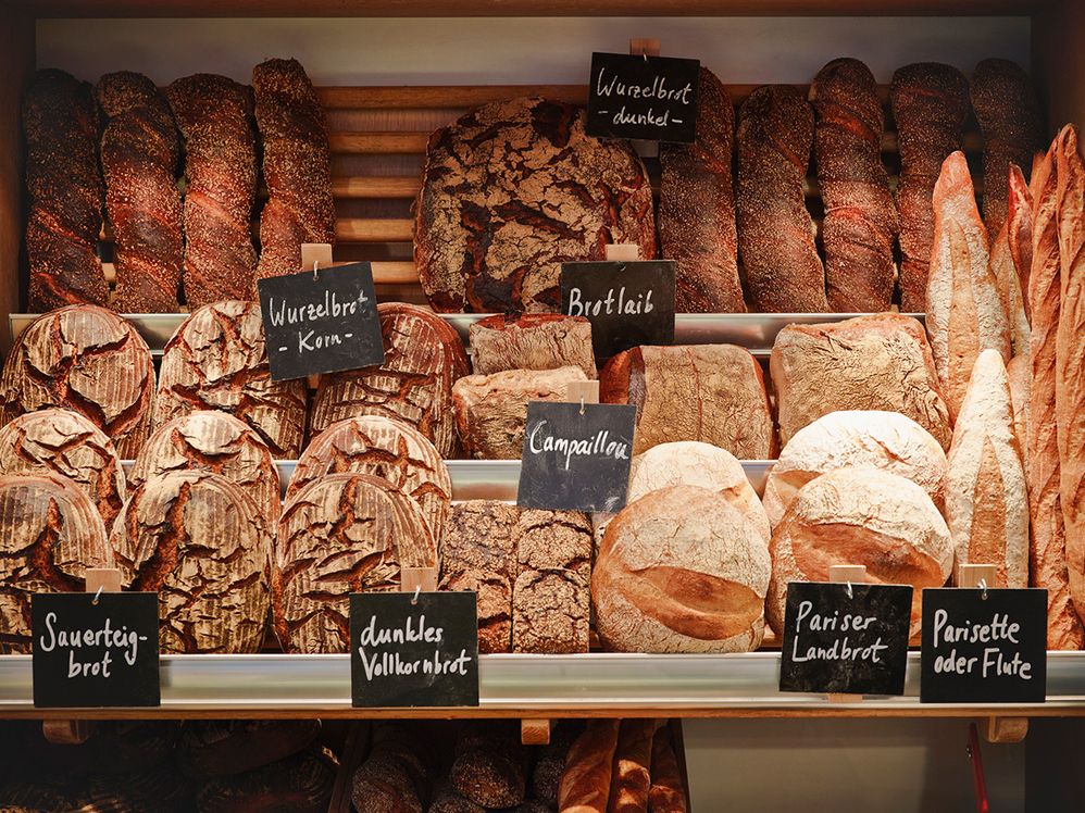 Caption: A photo of a variety of artisanal breads on display. (Getty Images)