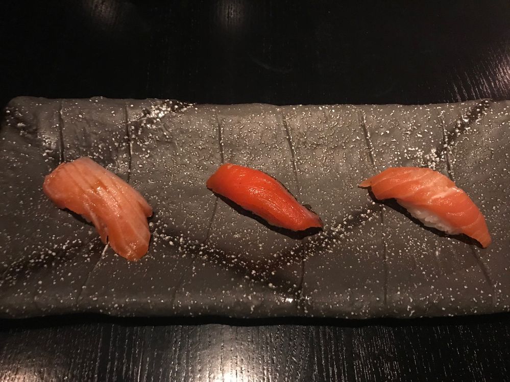 Caption: A photo of our first plate, three cuts of salmon each prepared differently.