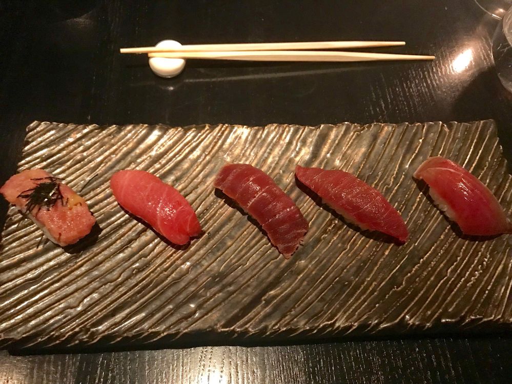 Caption: A photo of four cuts of blue fin tuna, each prepared differently, plus one piece of mackerel. This, and the salmon, were my favorite plates.