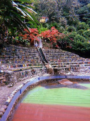 Photo of a thermal  water pool decorated  with colorful of bottles